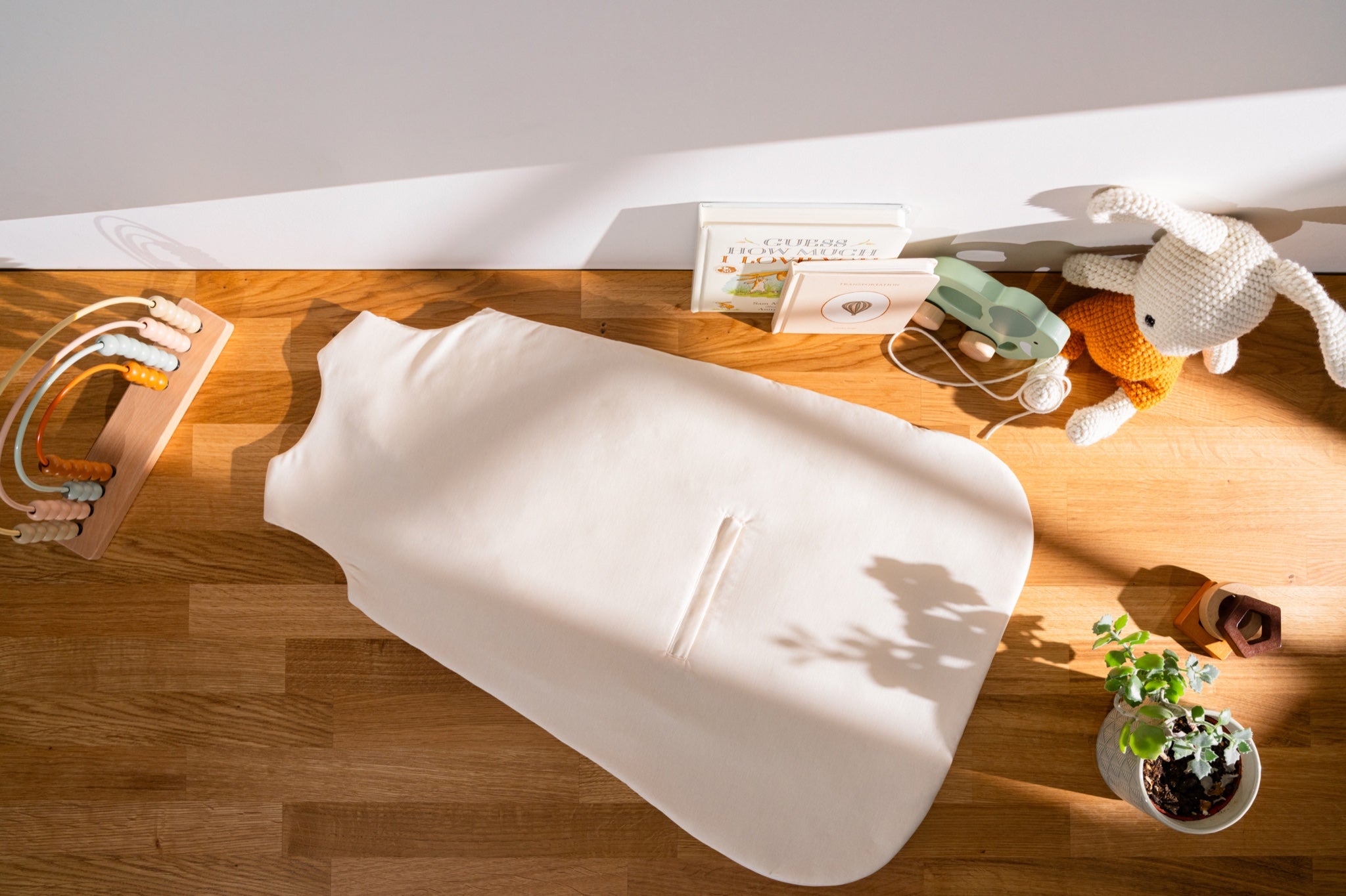 Nömad sleep sack laid flat, showing the car-seat harness opening